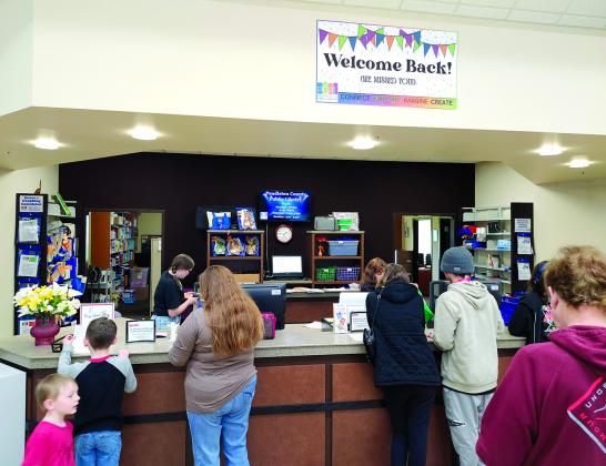 Patrons line up to check out materials Saturday at the Pendleton County Public Library’s Grand Reopening. Two hundred people turned out to see the renovations and new features completed since the library closed to in-person visits on Oct. 9.